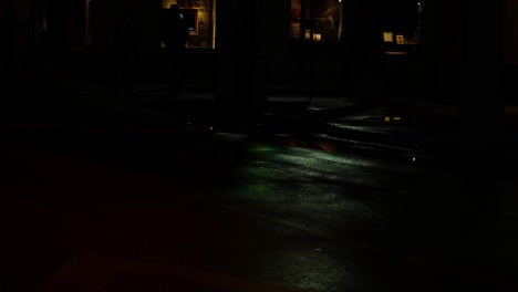 reflection on wet street from traffic light going from green to yellow to red light