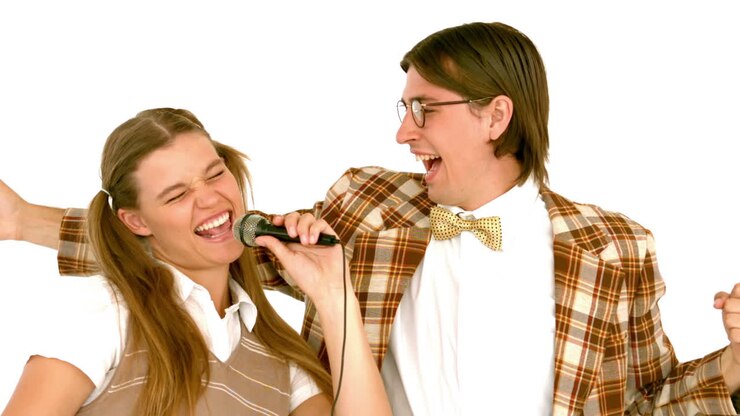 In slow motion happy geeky hipsters singing with microphone