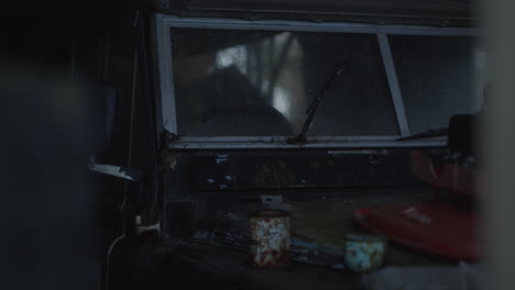 Handheld-looking-through-doorway-to-old-abandoned-jeep-car