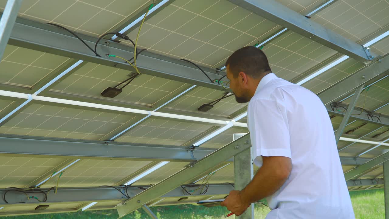 Engineer checking reverse side of solar battery