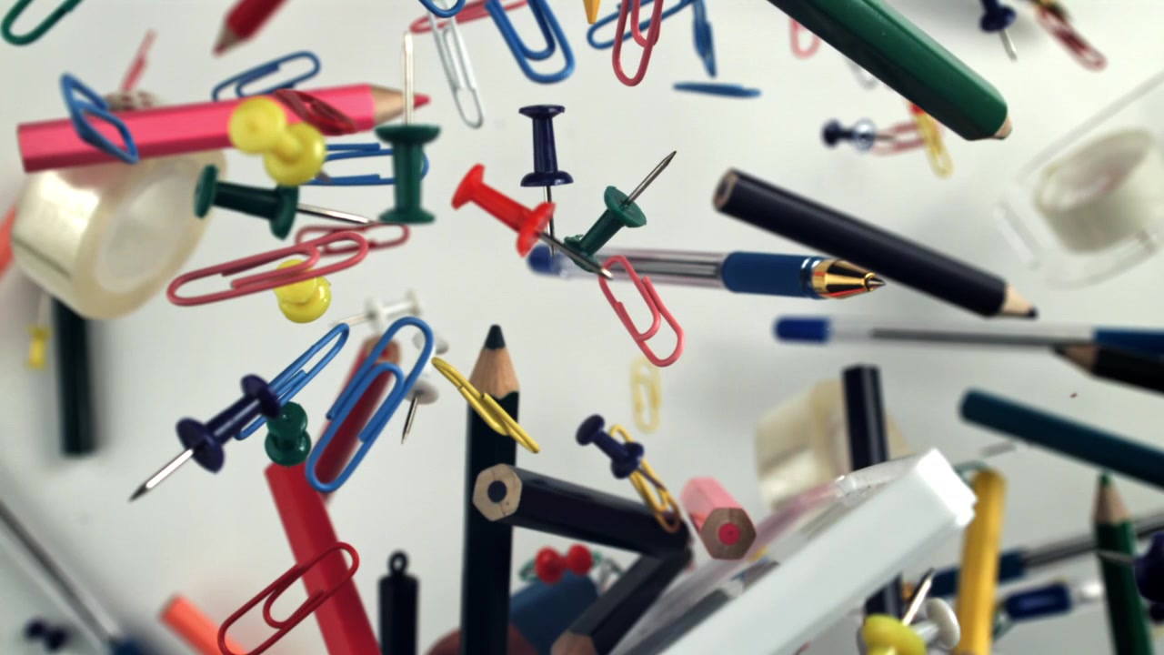 Colorful Office and Art Supplies Floating in Slow Motion