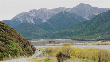 vehicles driving along the state highway through arthurs pass, new zealand