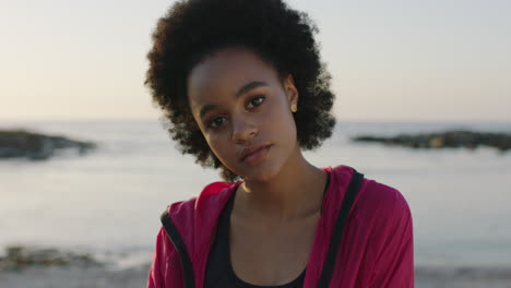 close-up-portrait-of-young-african-american-woman-looking-to-camera-beautiful-dreamy-eyes-on-calm-seaside-beach