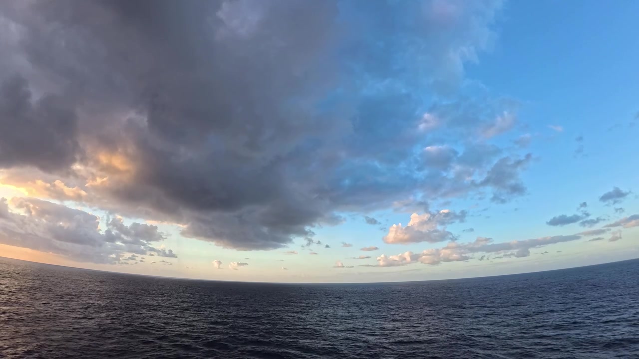 Vast Ocean Horizon with Dramatic Clouds at Sunset