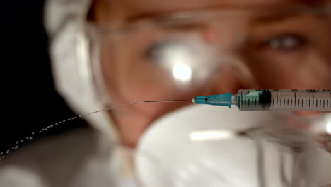 scientist spraying syringe of chemical