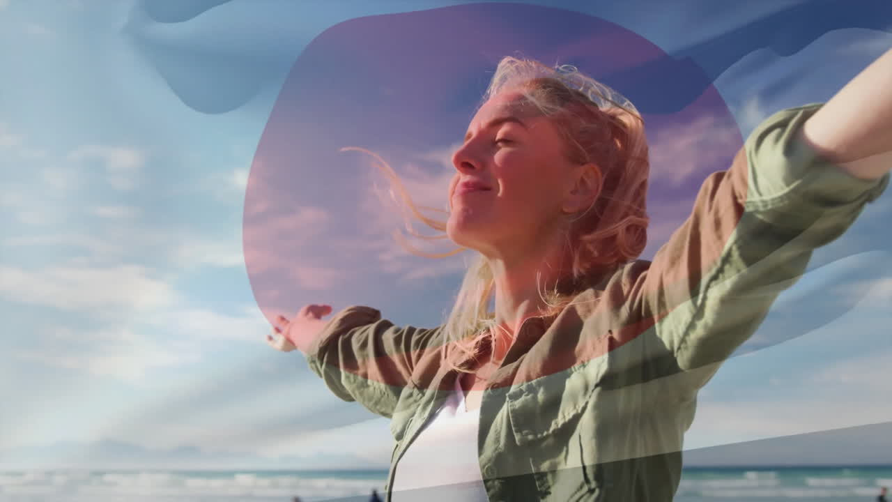 Enjoying ocean breeze, woman with colorful abstract animation shapes overlay