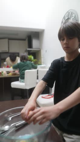 young boy preparing eggs in the kitchen