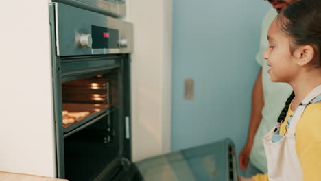 father, girl and baking oven for cooking