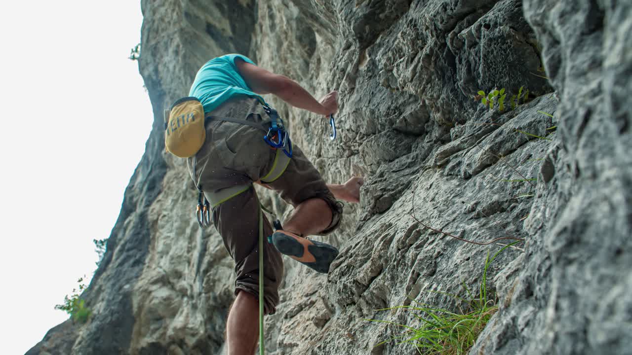 Climber with bare hands hanged on rocky wall. Topla, Slovenia