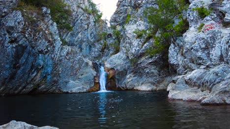 Natural-Boaza-Waterfall-with-a-small-lake-in-a-rocky-wooded-forest-site-located-in-Bulgari