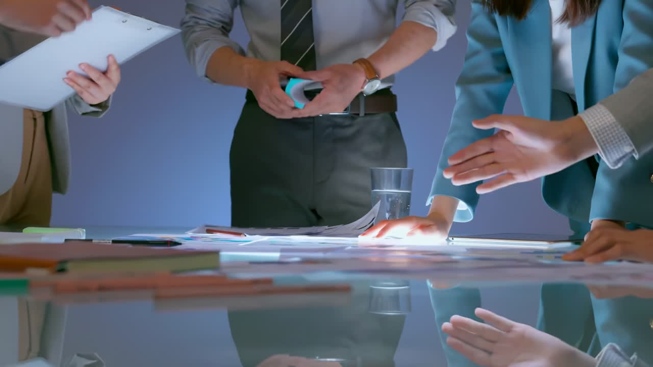 Business planning concept, experts working together in the meeting room office analysts strategizing on charts and data. Financial analysts discuss bars and graphs, using calculator to analyze data