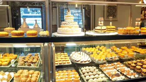 assortment of delicious cakes and pastries on display in a bakery