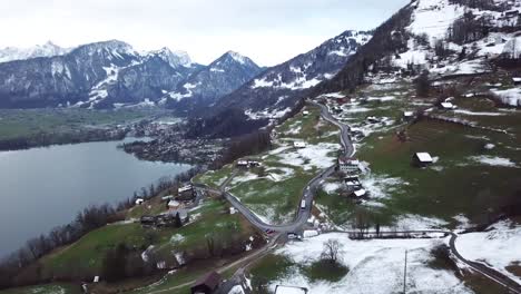 aerial push in flight to a mountain road with a bus driving in switzerland