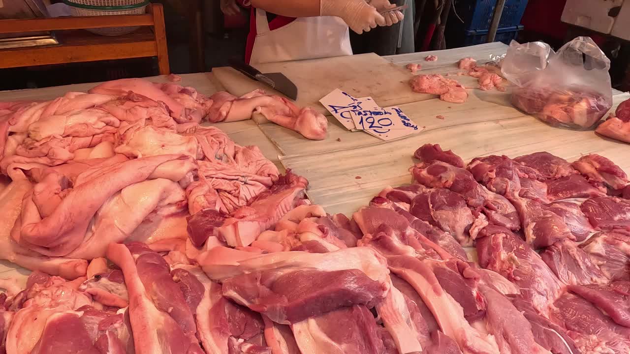 Assortment of raw meats on a wooden table