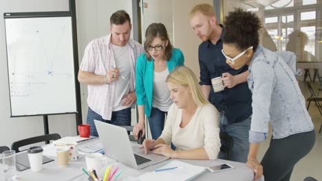 people in office watching laptop