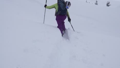 backcountry skier ascending through deep powder