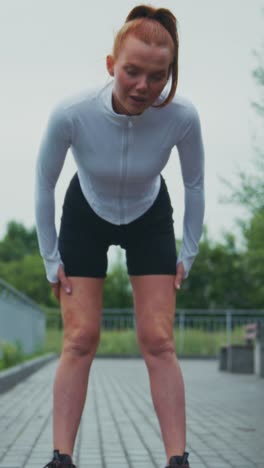 a young woman in athletic wear poses confidently outdoor, emphasizing fitness and style against a natural backdrop in these dynamic video frames
