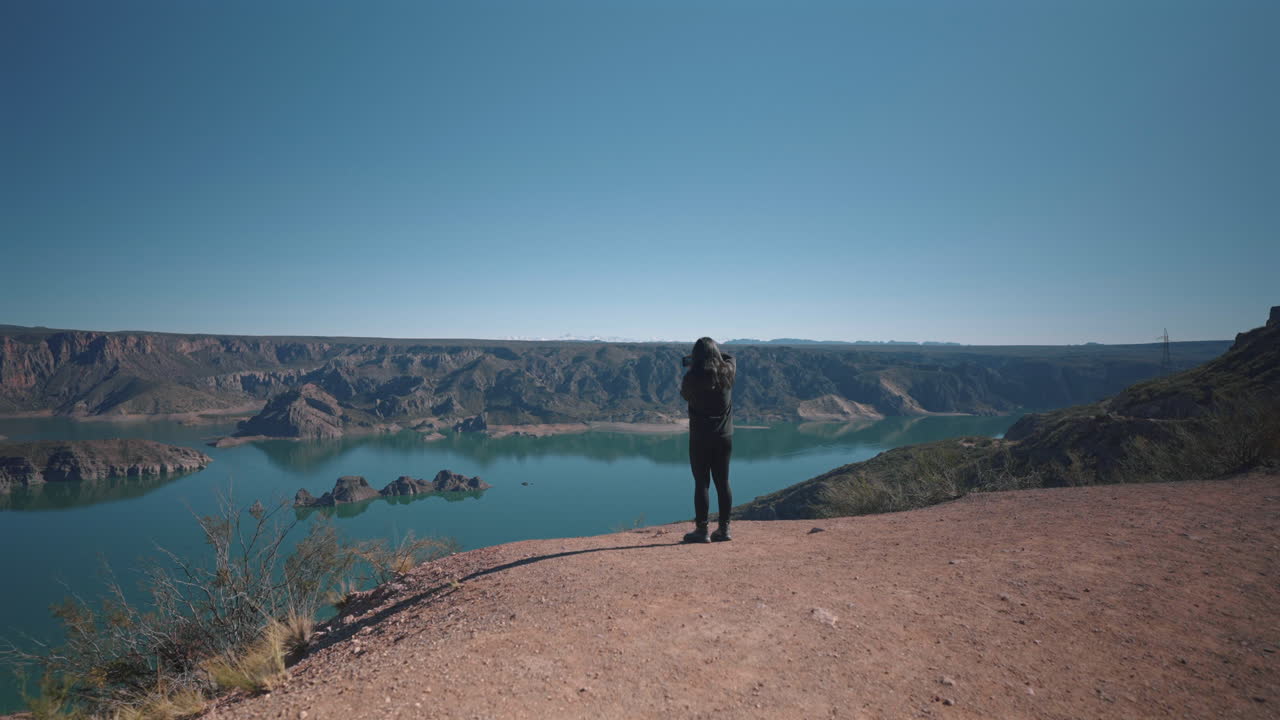 Person arriving to the Atuel Canyon viewpoint and taking some photos from the landscape, San Rafael, Mendoza Province, Argentina