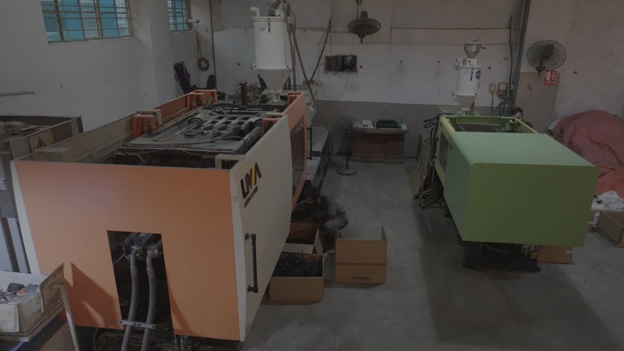 Profile view of automated machines getting serviced by technicians in PVC Pipe Making Factory in Karachi, Pakistan.