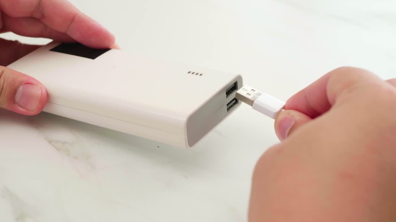 Man connect cable for charging power bank