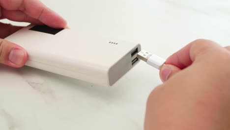 Man-connect-cable-for-charging-power-bank