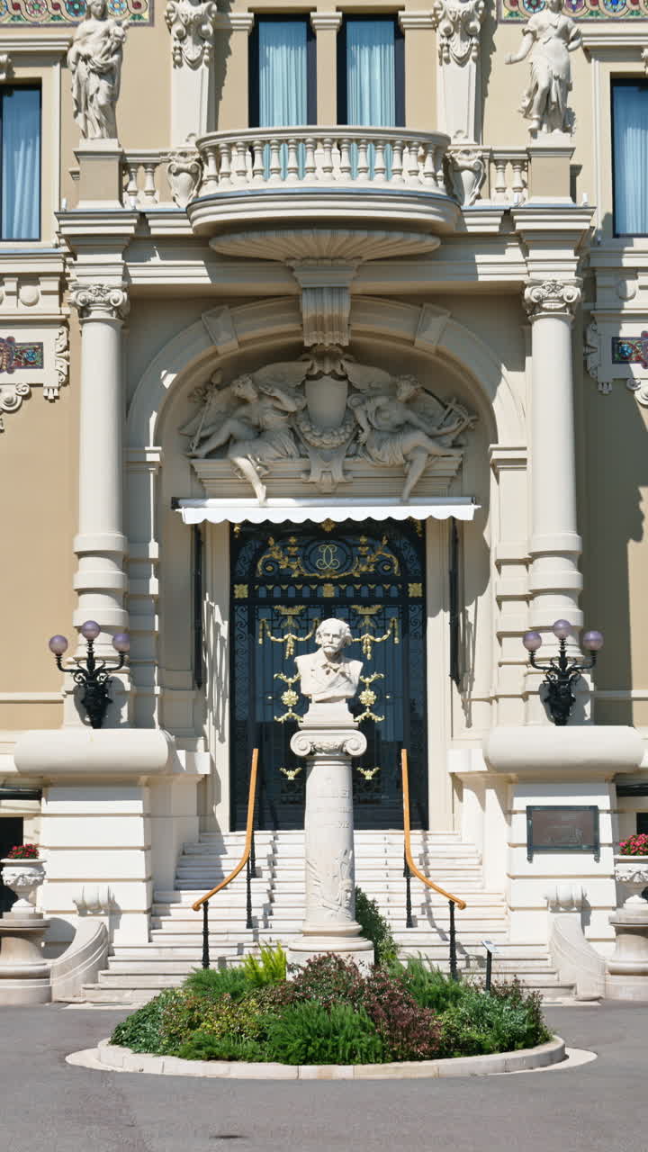 Close up of a statue in front of the Opera de Monte-Carlo in daylight. Vertical