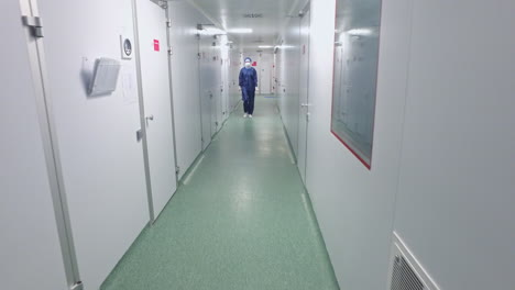 walking through laboratory corridor. female worker going chemical lab corridor