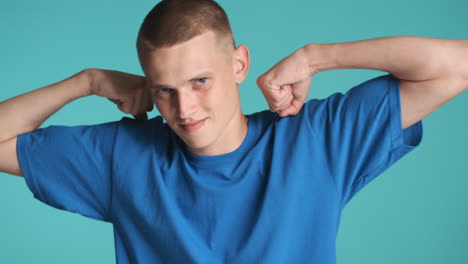 young man showing muscle in blue t-shirt