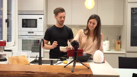 couple recording cooking tutorial for vlog