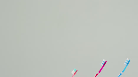 Video-of-close-up-of-toothbrushes-on-white-background