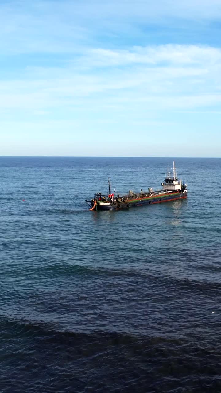 Dredging Vessel Cleaning Seabed in Sunny Spanish Waters, Environmental Focus