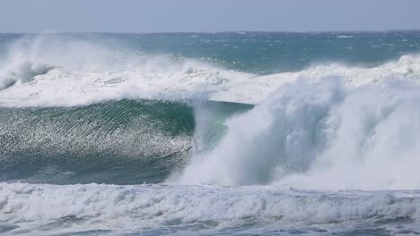 surfer riding massive waves during cyclone alfred at kirra beach