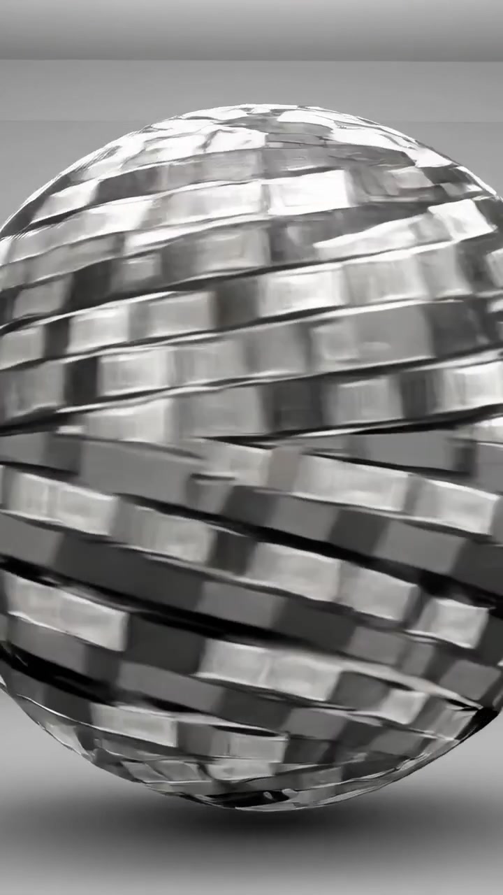 Video verticale: Sfera metallica rotante che reagisce all'interazione in studio, mostrando piastrelle a specchio