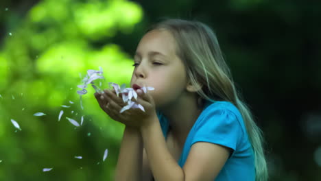 Girl-in-slow-motion-blowing-petals