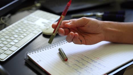 handwriting notes on a spiral notebook at a desk, symbolizing productivity, organization, or learning.