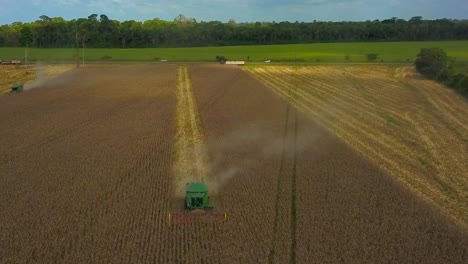 A-combine-harvester-gathering-soybeans-on-farmland-deforested