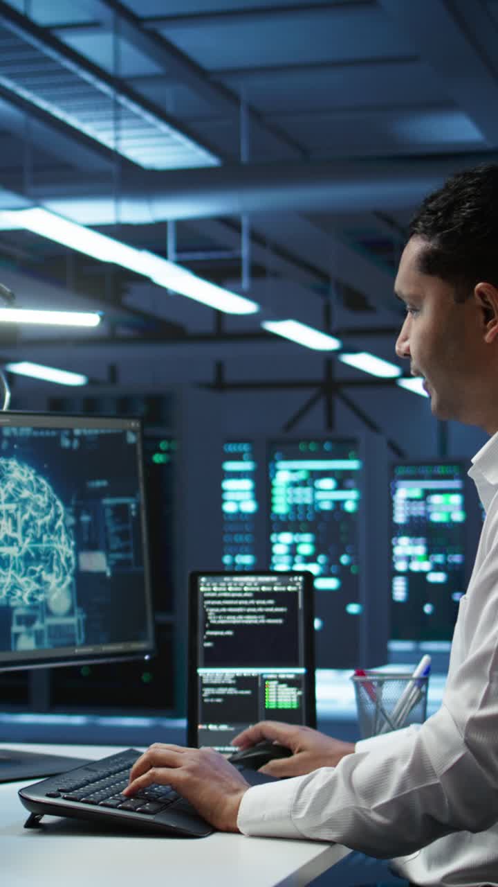 Man Working on Computers with AI Brain Graphic in Data Center