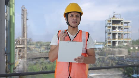 confused indian construction labour writing notes