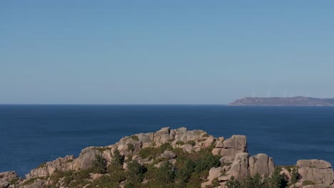 ascending on blue ocean and rocky cliffs in arou beach in galicia, a coruna spain