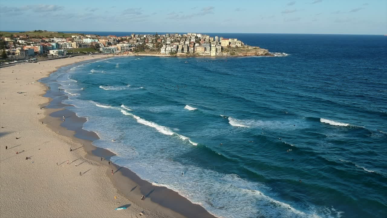 Surfers and bodysurfers from the air Sydney Bondi Beach 4k drone