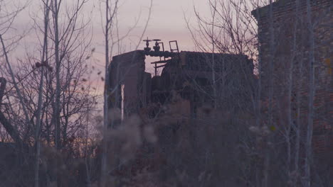 focus-rack-to-abandoned-factory-building-as-the-sun-sets