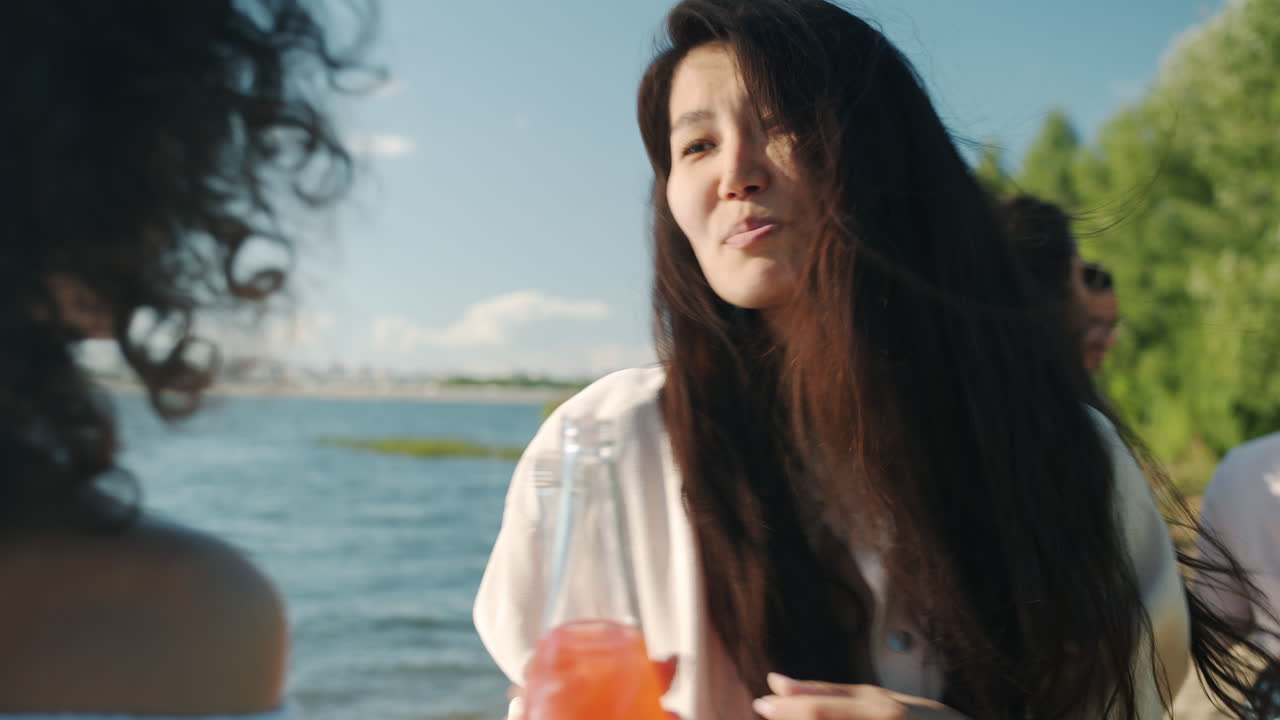 Friends Enjoying Drinks at the Lakeside Picnic