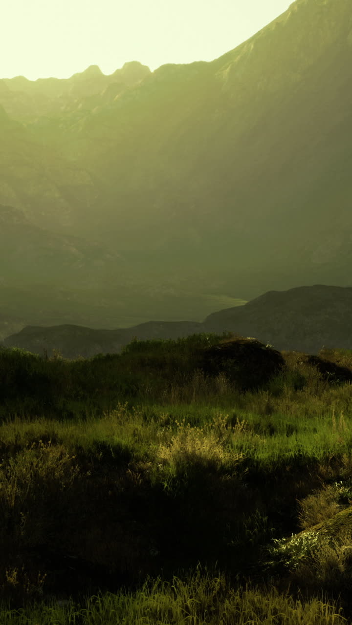 Sunrise over tranquil mountain valley surrounded by lush greenery