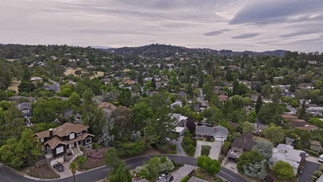 Redwood-City-California-Aerial-v4-low-flyover-farm-hills-neighborhood-with-emerald-hills-views-capturing-residential-houses,-homes-built-on-hilly-landscape---Shot-with-Mavic-3-Cine---June-2022