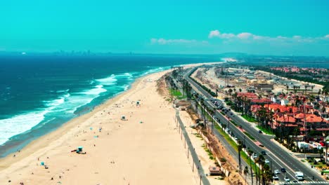 hyperlapse over pacific coast highway in huntington beach california looking at the traffic on pch and some large waves breaking on the shore