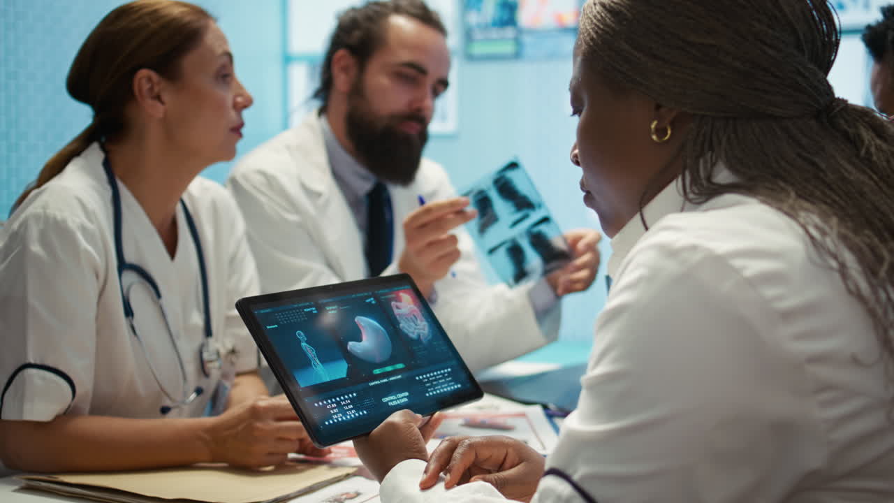 Medical Team Analyzing X-rays and Scans on Tablet
