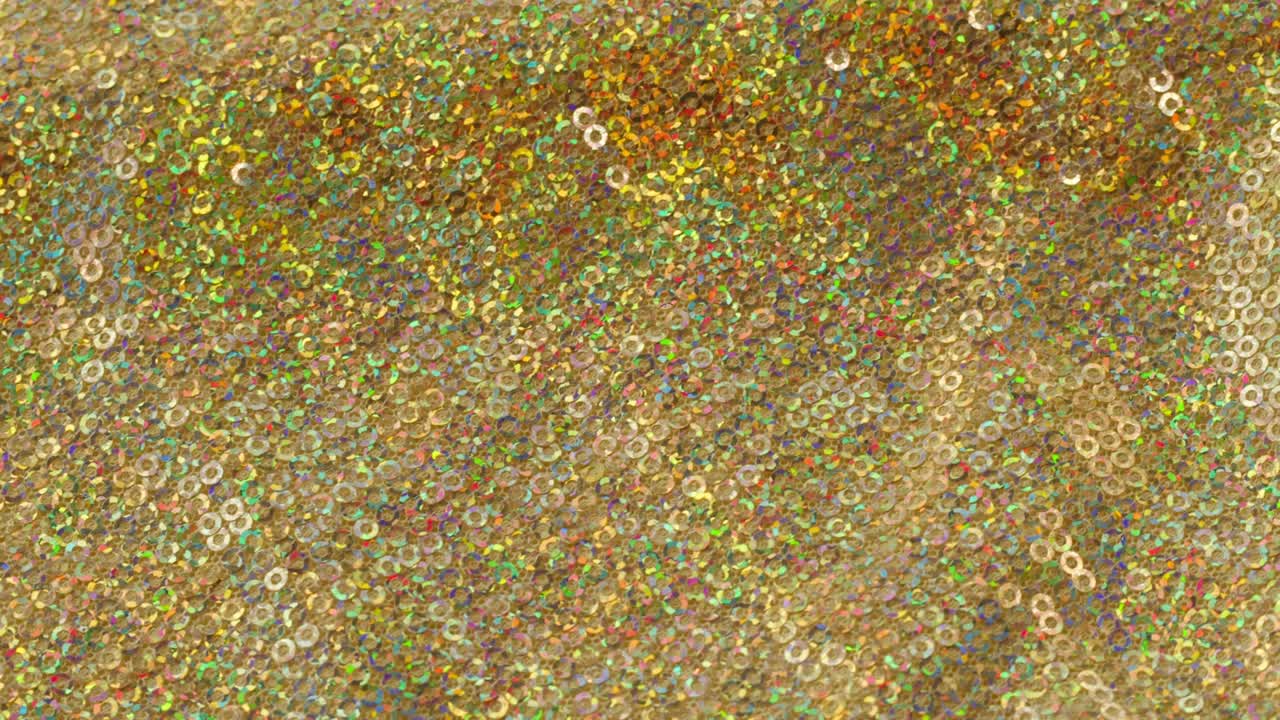 tela brillante brillante con pañuelos de primer plano. confeccionando ropa festiva. fondo brillante dorado. concepto de coser vestido de año nuevo