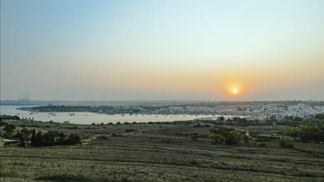 Holy-Grail-Sunset-Timelapse-overlooking-Marsaxlokk-and-the-Freeport-in-Malta