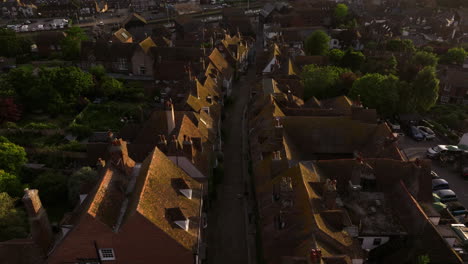empty street along the old buildings in rye town during sunset in east sussex, england, uk. - aerial shot