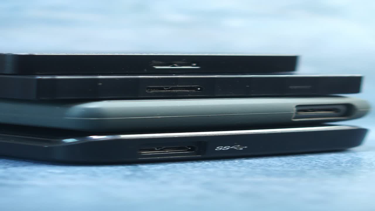 Stack of external hard drives and power banks